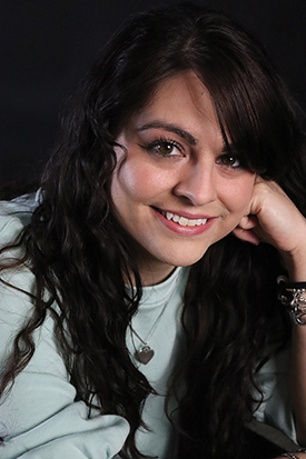 Portrait of a girl in a mint green shrit.
